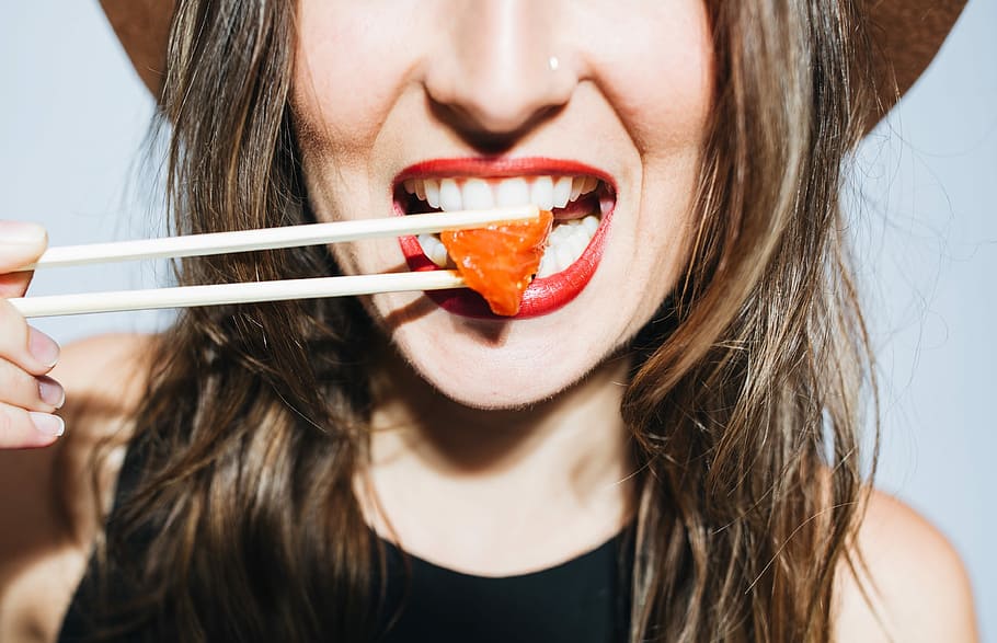woman eating meat dish using chopsticks, portrait, food, close-up HD wallpaper
