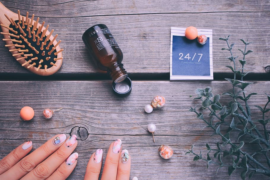 brown glass bottle near human hand and earrings, wood - Material HD wallpaper