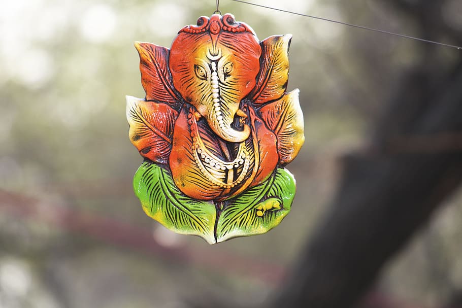 selective focus photography of orange elephant decor, ganpati
