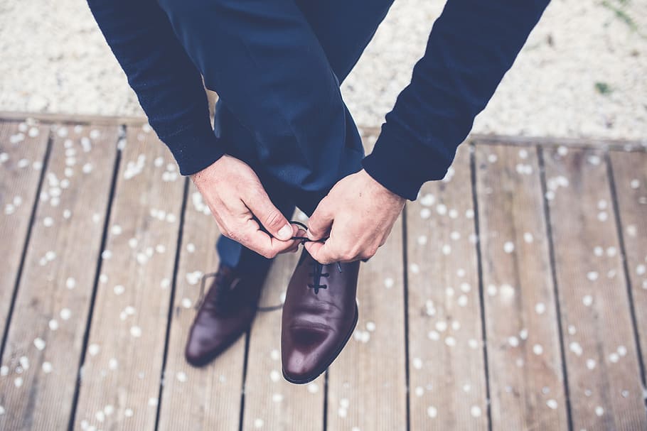 man lacing up his brown leather oxford shoe on the right side, HD wallpaper