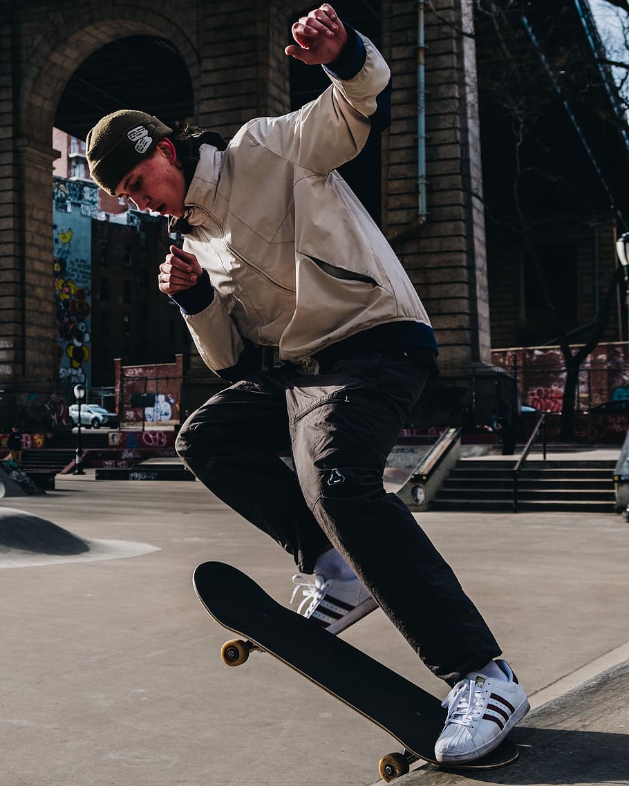man playing skateboard on street, man skateboarding on street