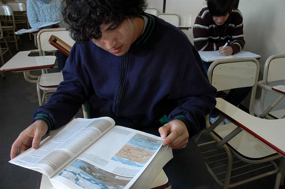 man in blue zip-up jacket reading book, classroom, student HD wallpaper