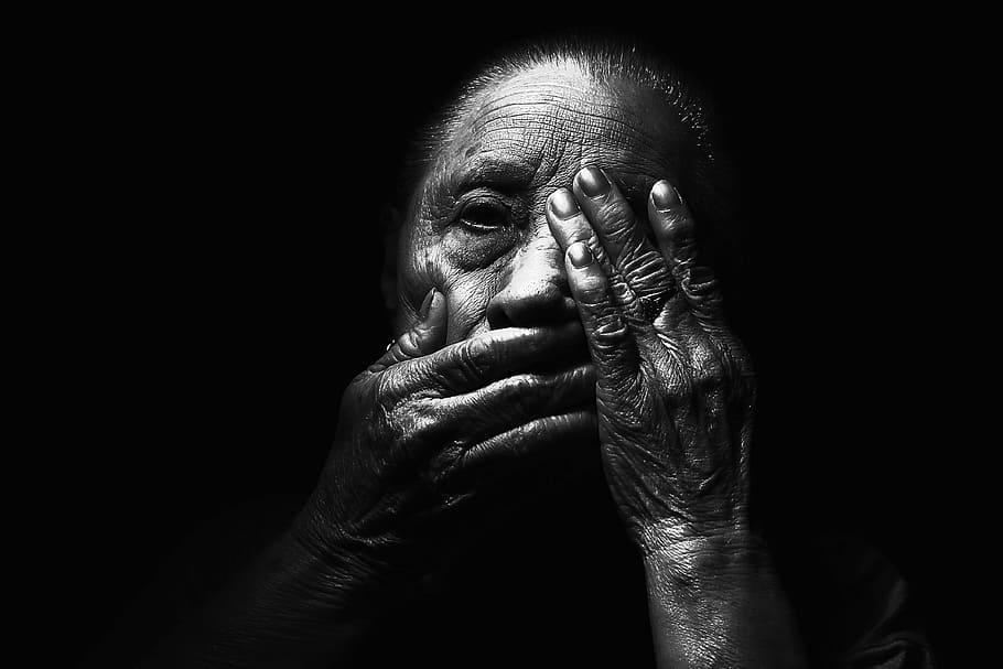 grayscale photo of person, adult, aged, blur, dark, face, hands