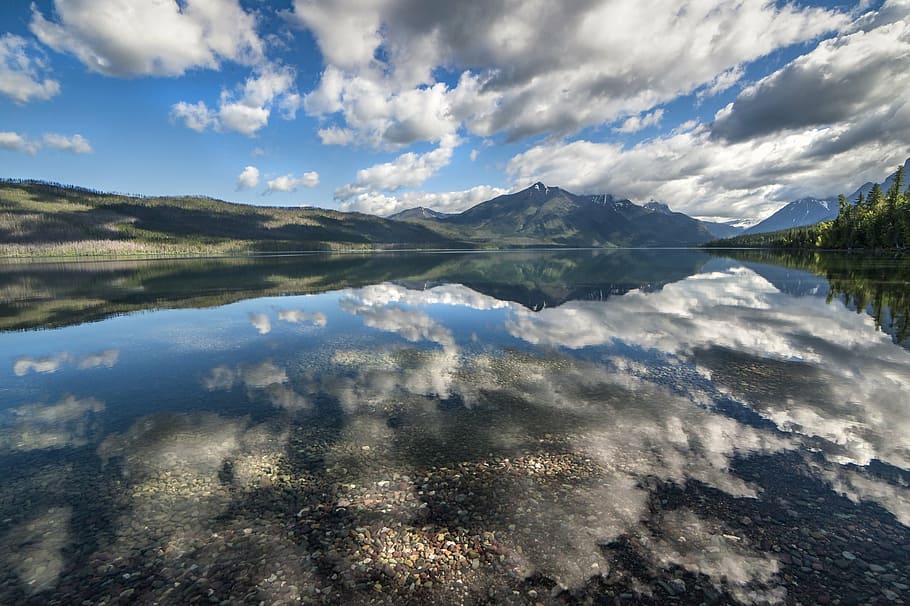landscape photography of mountains surrounded by body of water during daytime HD wallpaper
