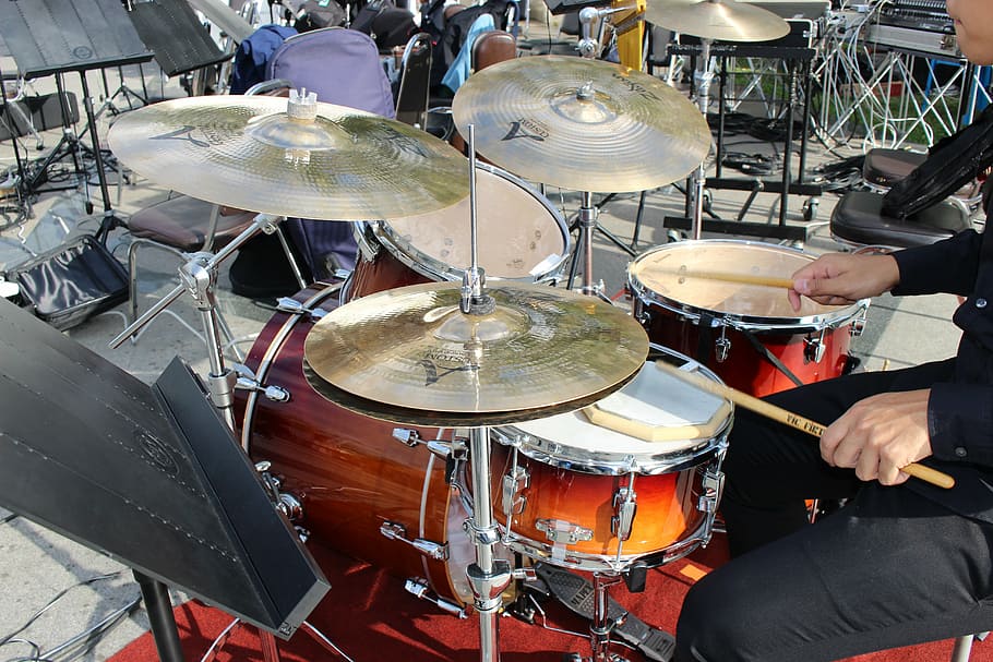 person playing drum set, drumming, percussion, cymbals, music