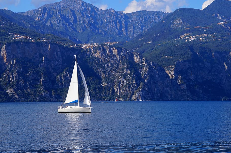 white sailing boat in sea near cliff, holiday, italy, garda, water