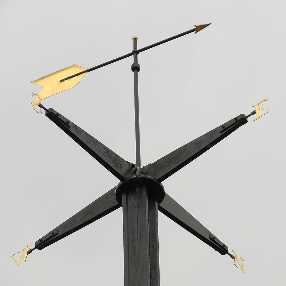 low-angled photography of black windvane, compass, compass rose