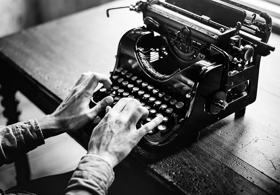 grayscale photo of person using typewriter, adult, alphabet, ancient
