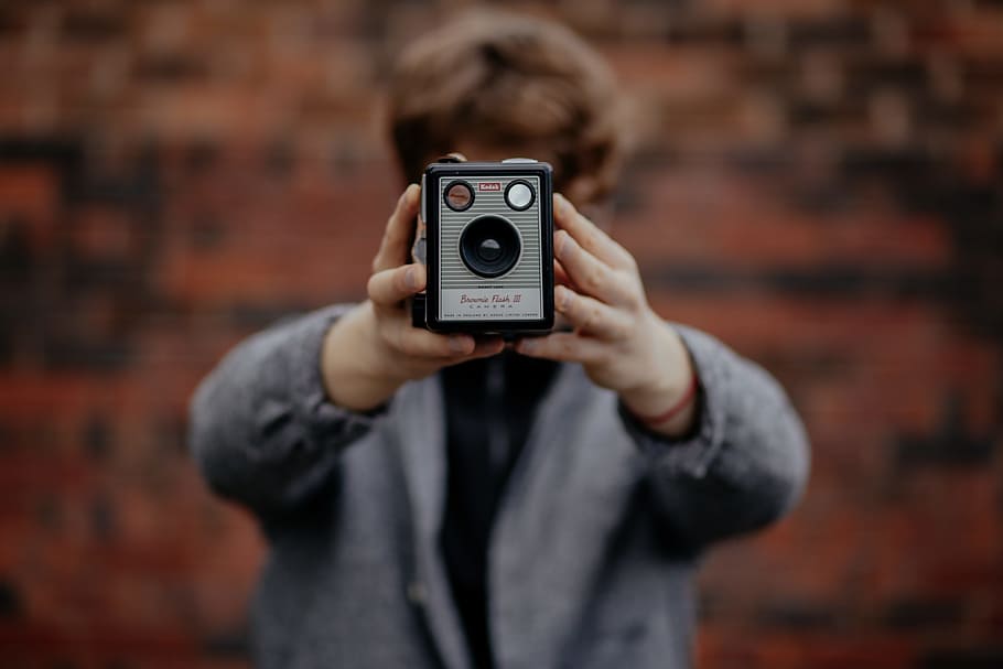 selective focus photography of person holding grey and black camera, selective photography of men holding gray device HD wallpaper
