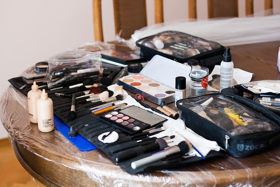 assorted-color cosmetic product lot on top of brown table, makeup HD wallpaper