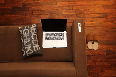 silver MacBook on brown couch, home office, notebook, sofa HD wallpaper