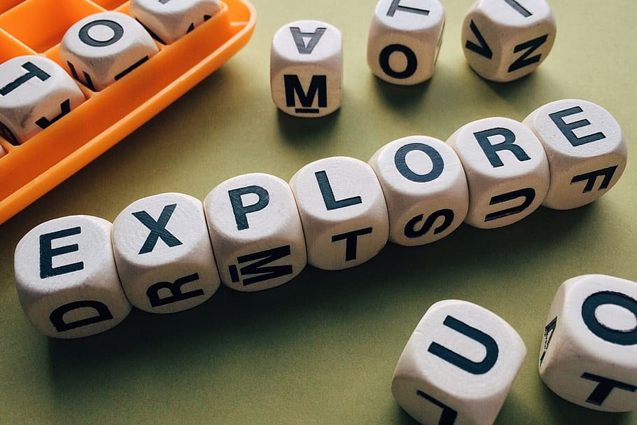white and black explore cubes on green table, alphabetical HD wallpaper