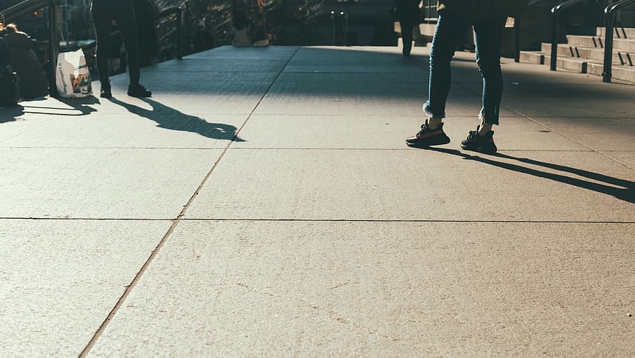 person in blue jeans standing on concrete ground, person standing on pavement HD wallpaper