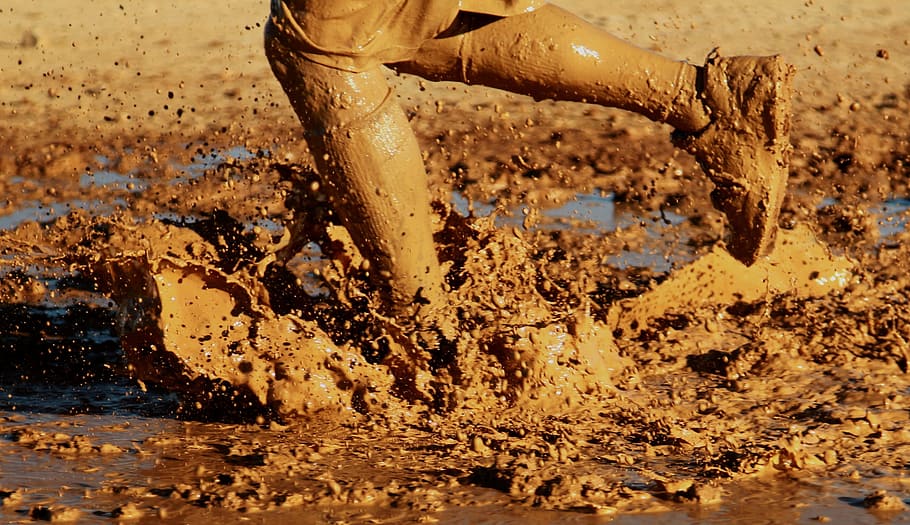 person on mud during daytime, running, water, outside, muddy