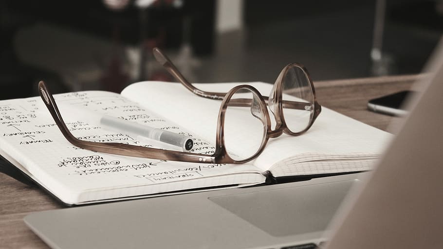 eyeglasses with gray frames on the top of notebook, brown framed eyeglasses above of notebook HD wallpaper