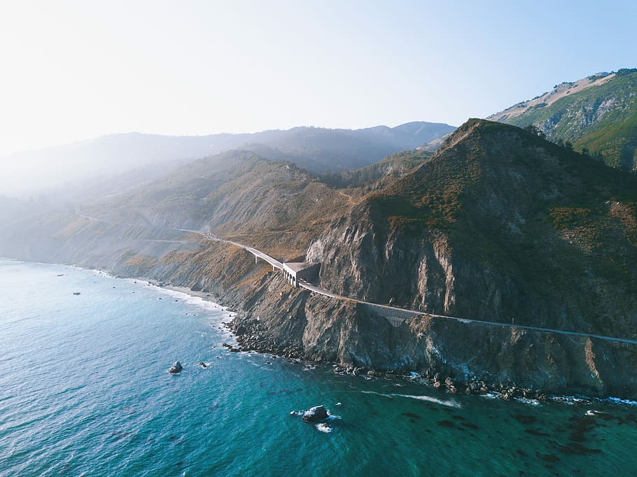 aerial view photography of mountain near body of water, aerial photography of mountain range and body of water HD wallpaper