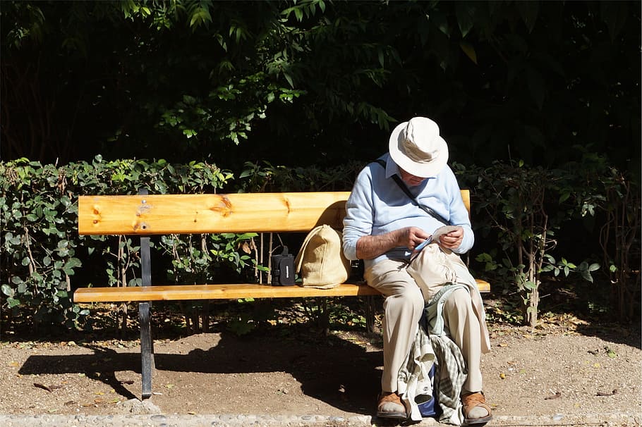 man sitting on wooden bench, old, elderly, reading, hat, one person HD wallpaper