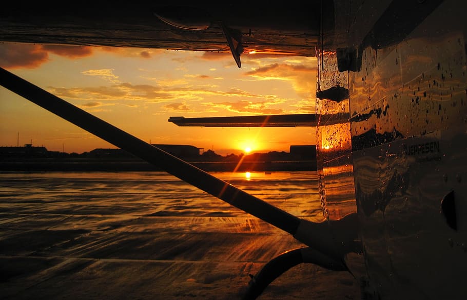sunset, setting, tarmac, glow, orange, aircraft, sky, water HD wallpaper