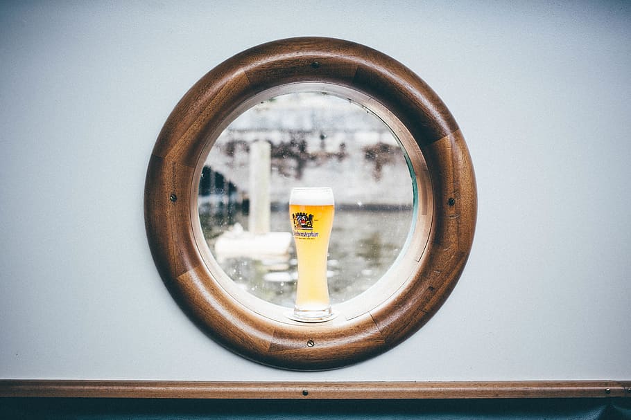 clear drinking glass on round brown wooden window, boat window HD wallpaper