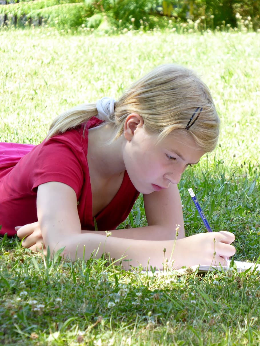 girl laying on grass field while writing on lined paper, leave, HD wallpaper