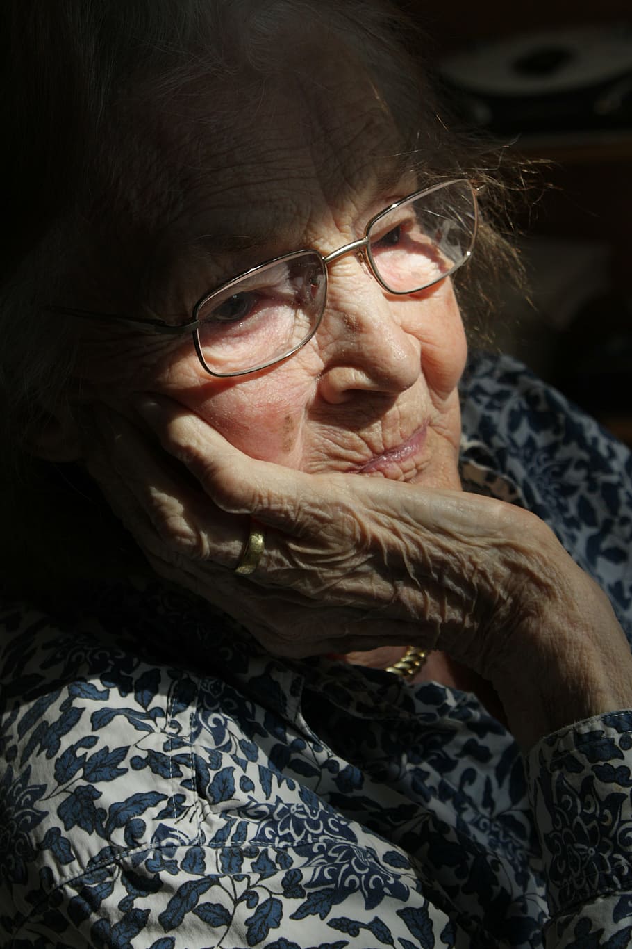 woman wearing eyeglasses looking down, old, age, retirement home