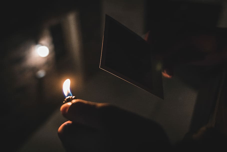shallow focus photography of person holding a lighter, person holding lighted disposable lighter, HD wallpaper