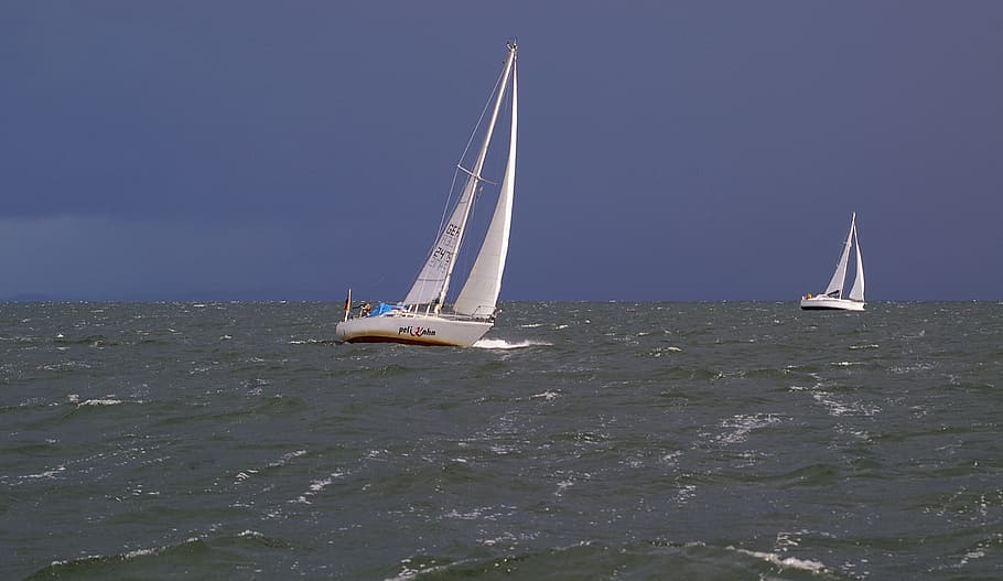 two white boats bending over left side, sailing vessel, ship
