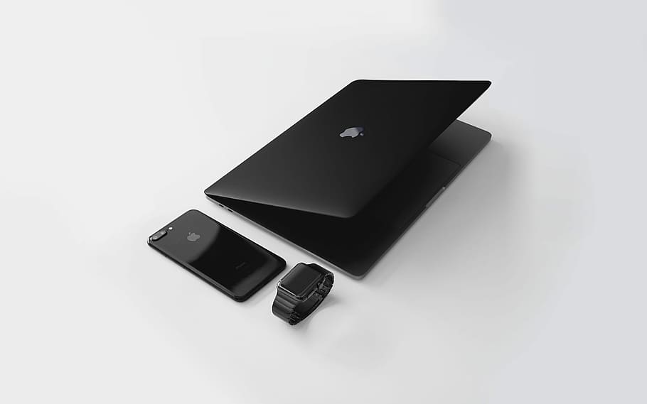 black Macbook near black iPhone 7 Plus and black Apple Watch, black MacBook beside jet black iPhone 7 Plus and Apple Watch