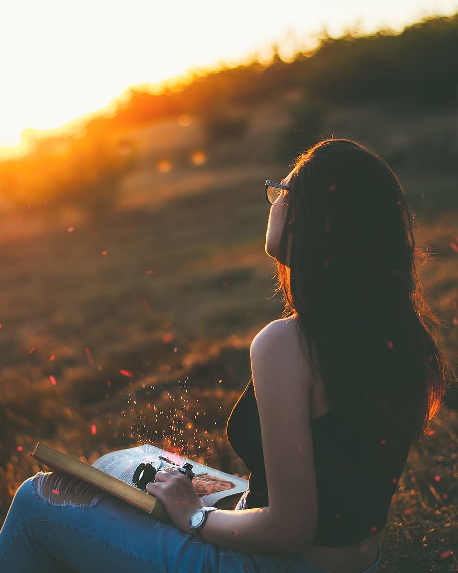 book on woman's lap sitting on grass during golden hour, women HD wallpaper