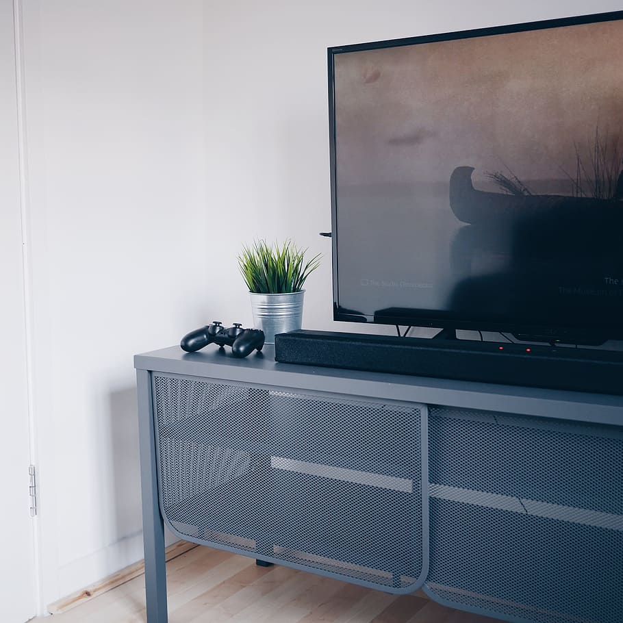 flat screen TV on gray wooden TV stand inside room, technology HD wallpaper