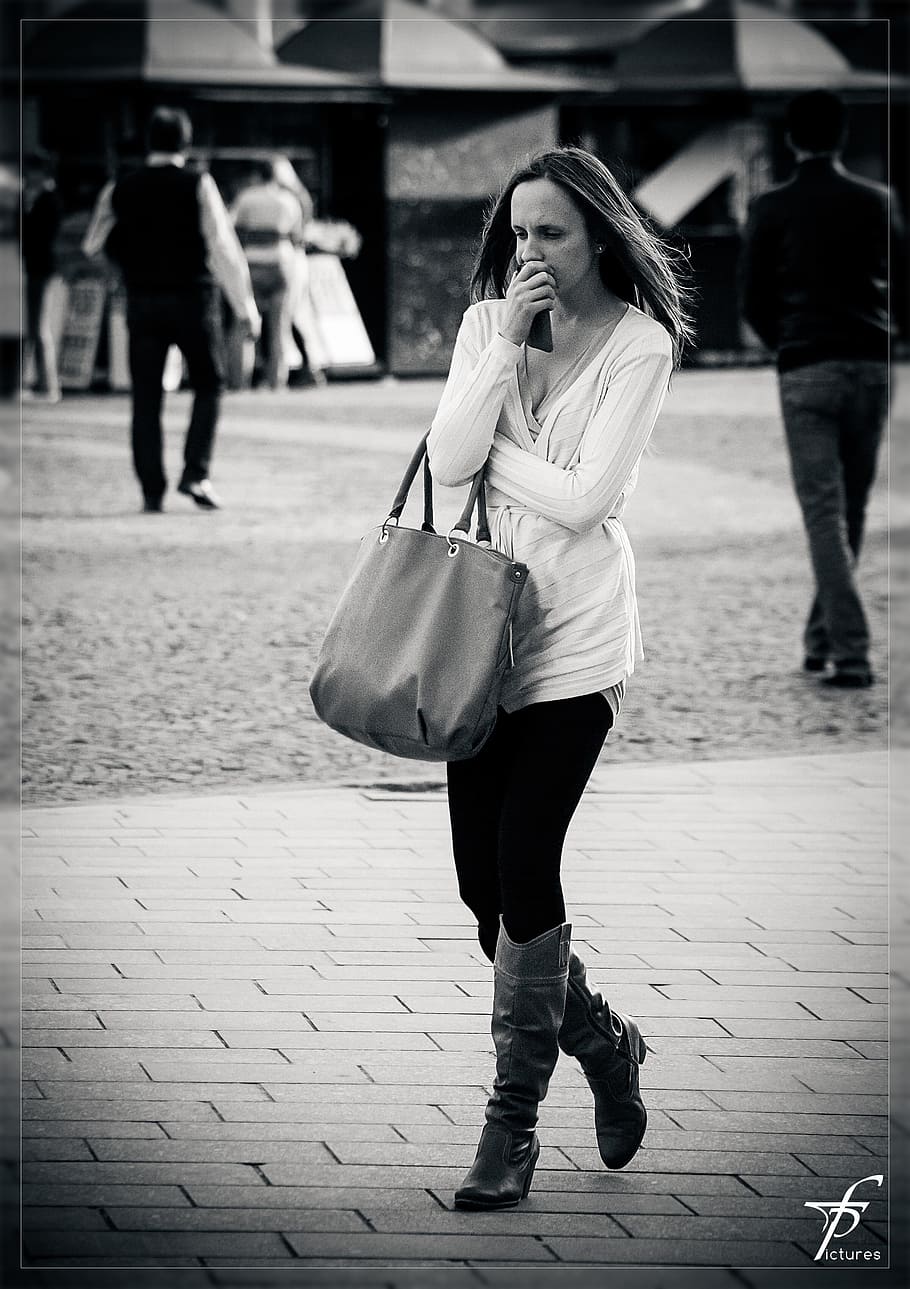 grayscale photo on woman walking on brick floor, thinking, in thought