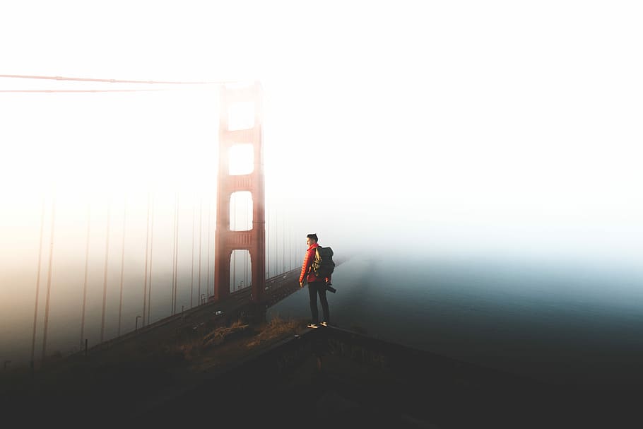 man standing near Golden Gate bridghe, person standing on cliff near golden gate bridge at cloudy sky during daytime HD wallpaper