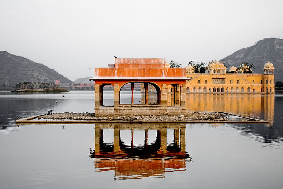 brown concrete building surrounded by water during daytime, brown landmark structure HD wallpaper