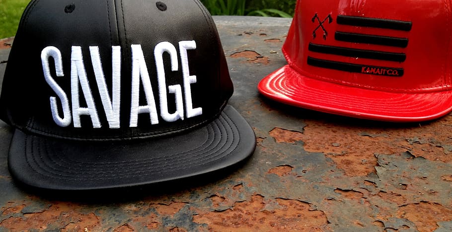 two red and black flat-brimmed caps on gray surface, hats, savage HD wallpaper