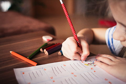 girl holding red pencil writing on white printing paper, child HD wallpaper