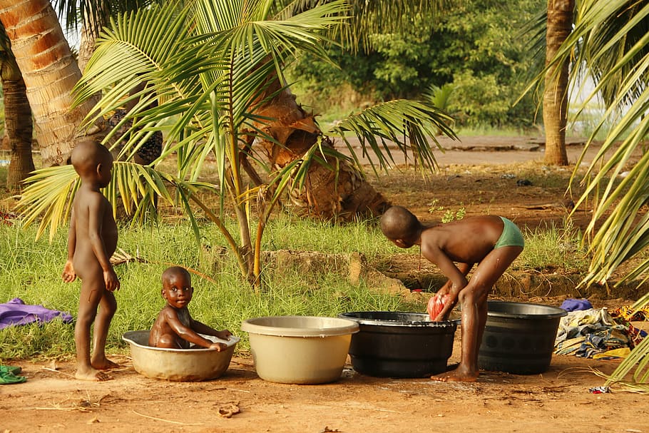 kids bathing near trees during daytime, benin, africa, child