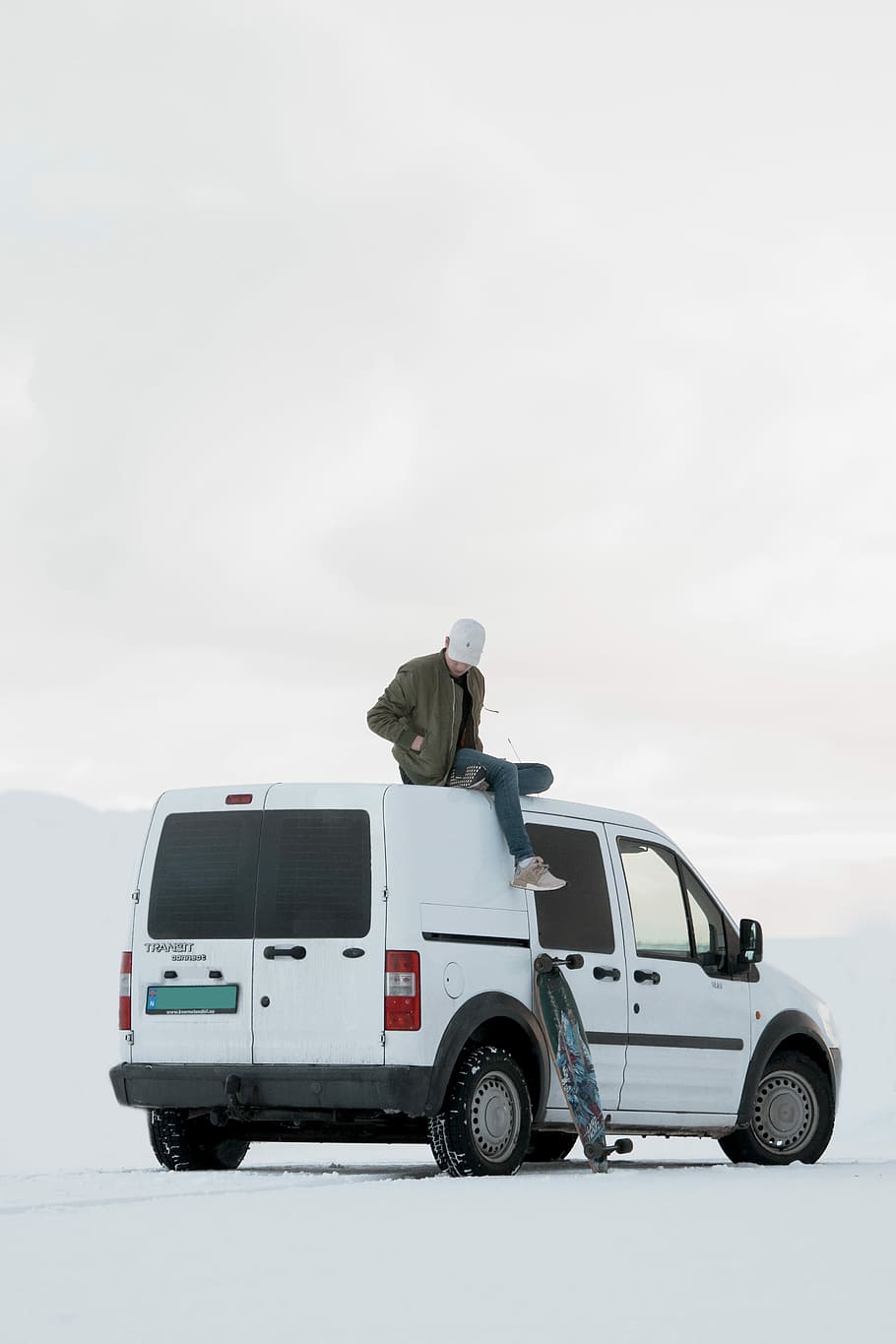 man sitting on top of white minivan during daytime, man on top of the white van HD wallpaper
