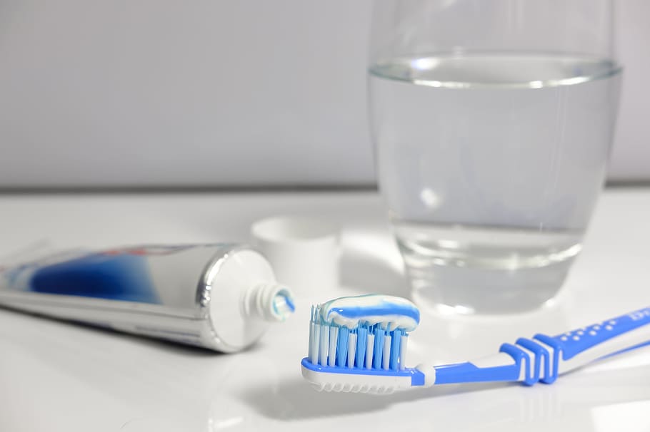 blue and white toothbrush beside white and blue toothpaste soft-tube, HD wallpaper