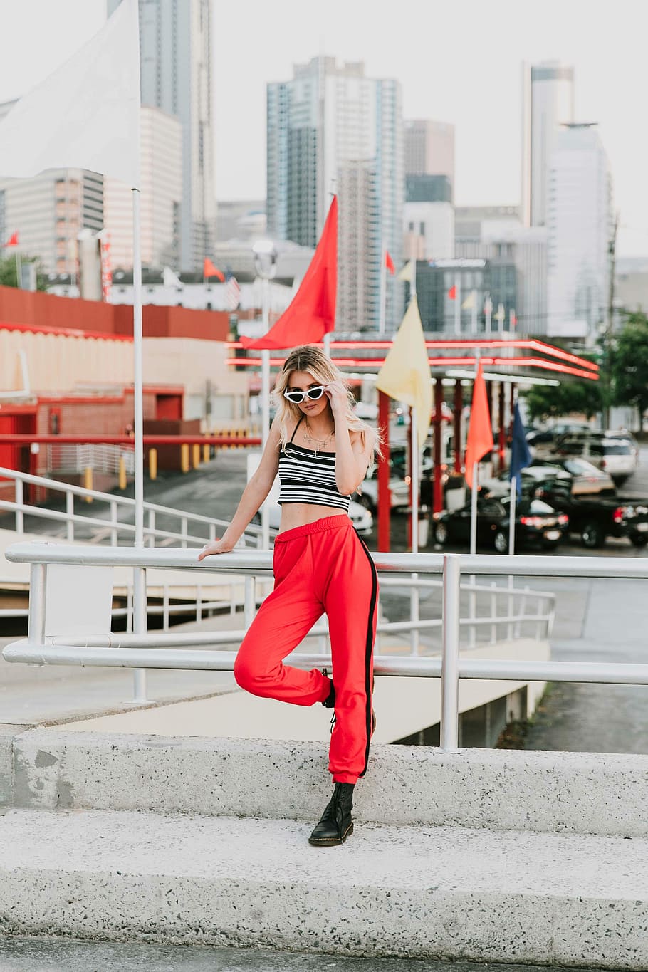 Women's Black Tank Top And Red Track Pants Walking On Street
