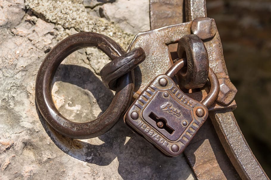 close-up photo of brown Boss metal padlock, castle, closed, solid