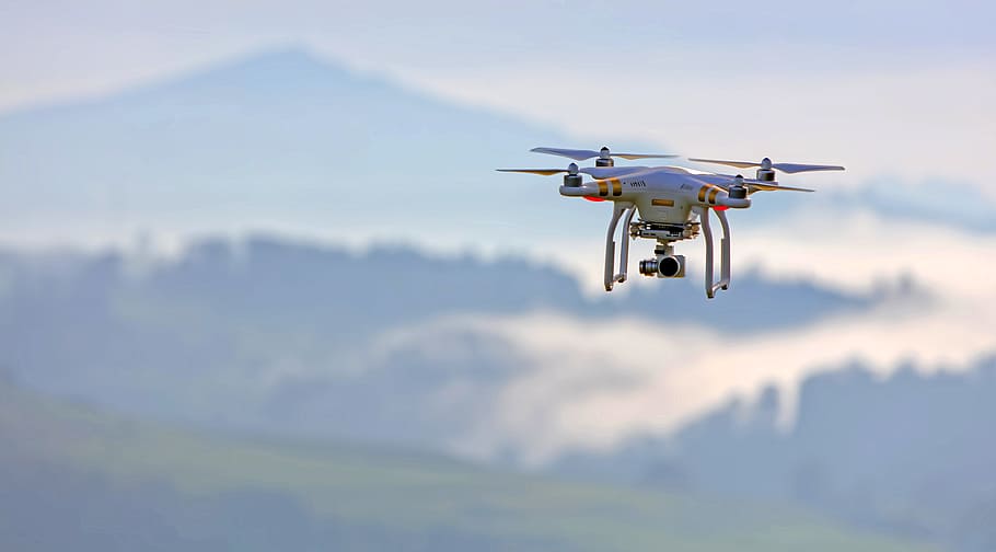 shallow focus photo of white quadcopter, white and red quadcopter drone flying in the air HD wallpaper