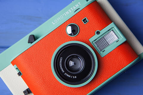 Close-up shot of a retro style film camera and lens, image captured with a Canon 5D DSLR on a blue wood desk HD wallpaper