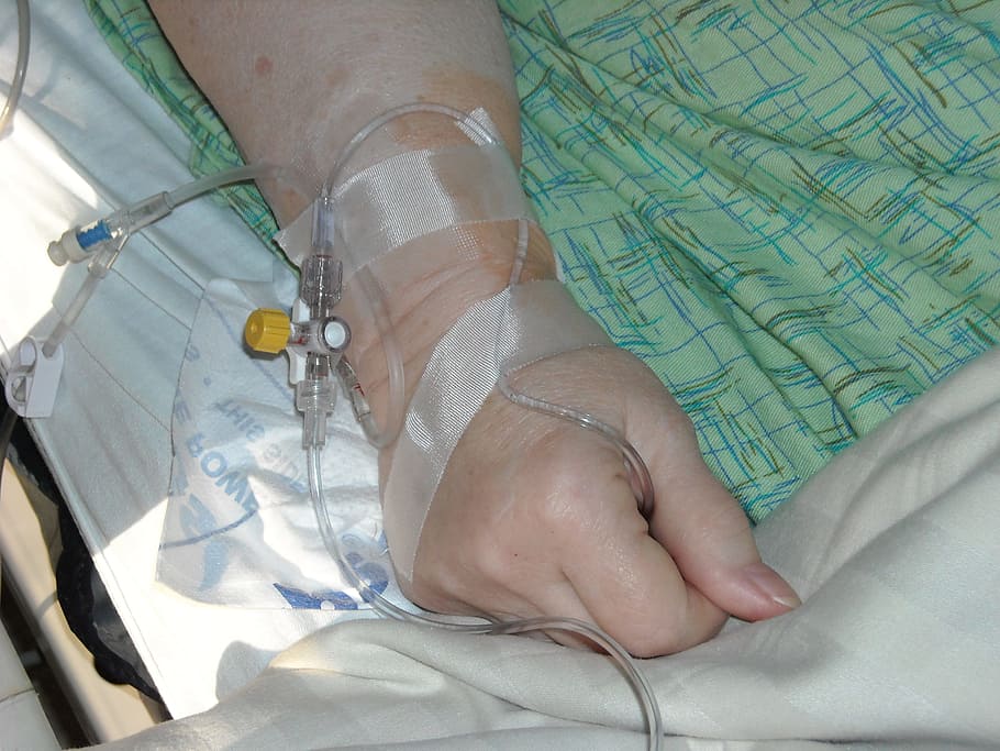 person lying on hospital bed, intravenous, hand, wrist, medical