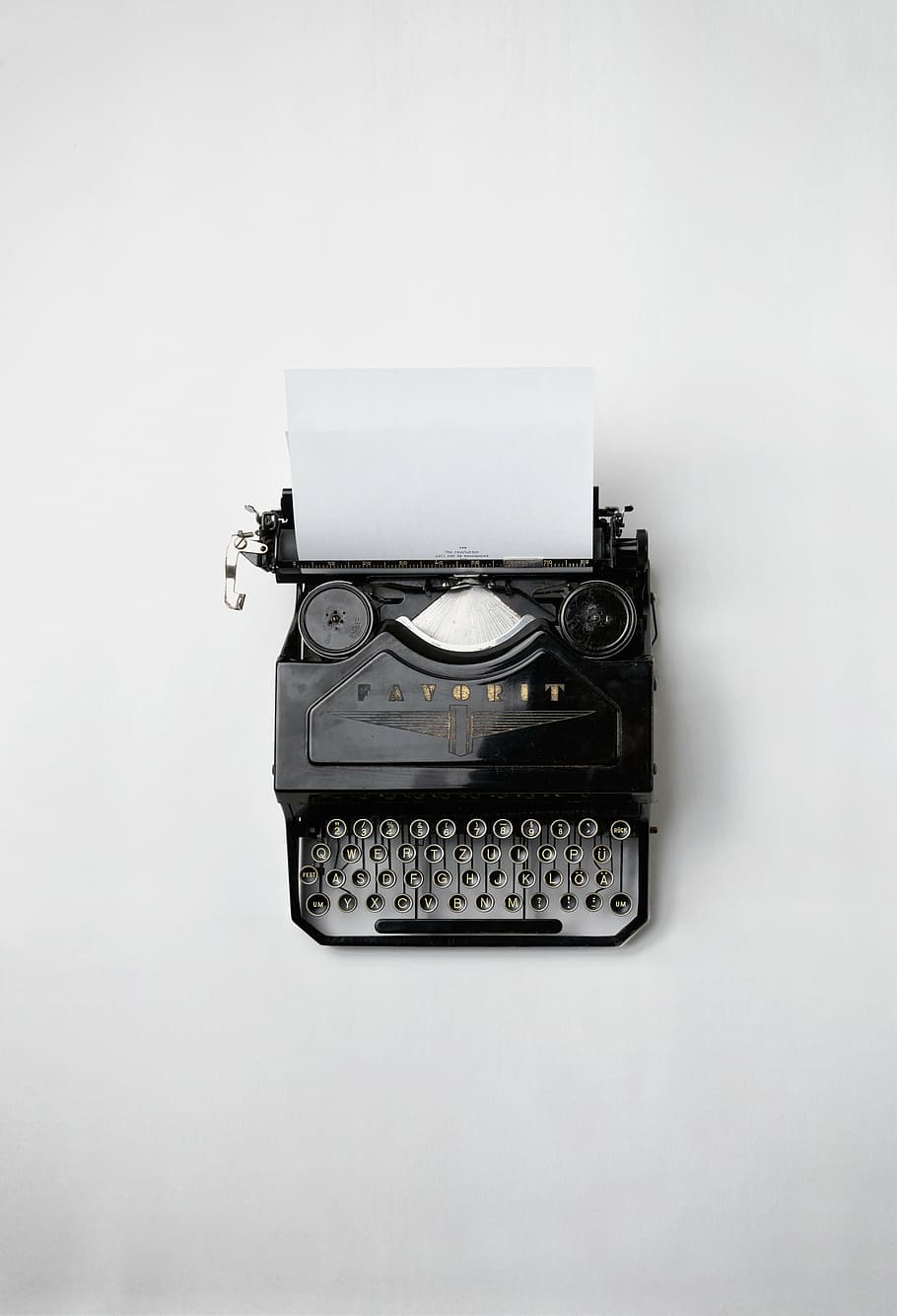 black typewriter on white surface, printed, paper, old, vintage