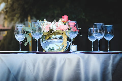 clear wine glasses and red rose flower arrangement on table outdoors during daytime HD wallpaper