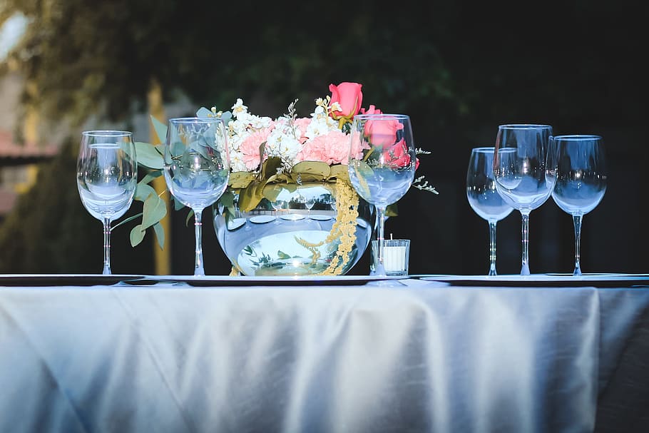 clear wine glasses and red rose flower arrangement on table outdoors during daytime HD wallpaper