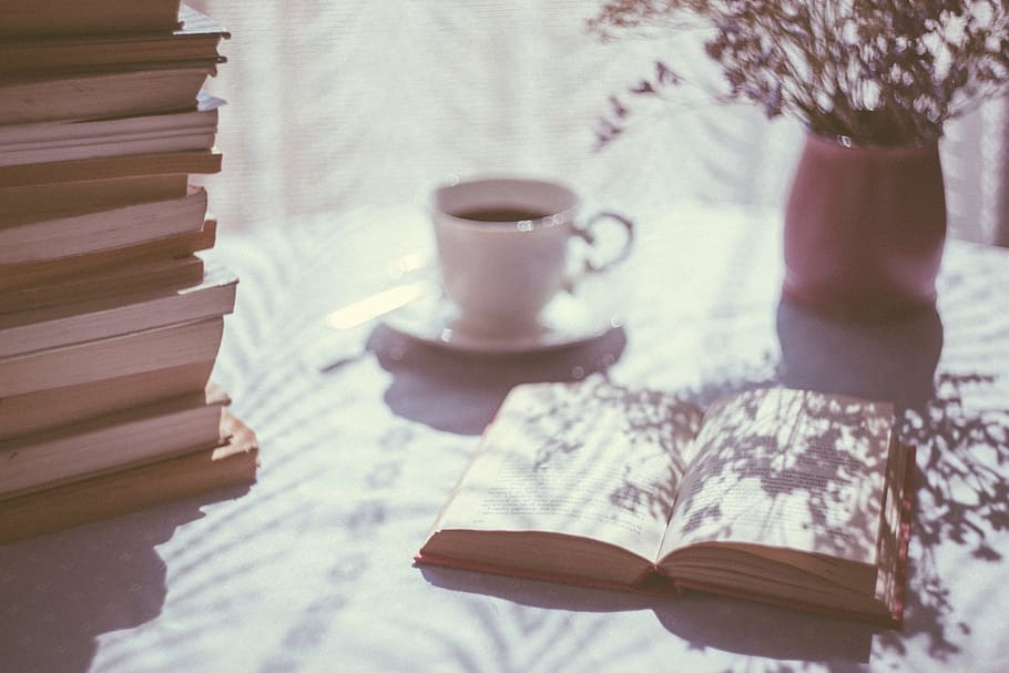 open book beside white ceramic mug and pink ceramic vase on top of table HD wallpaper