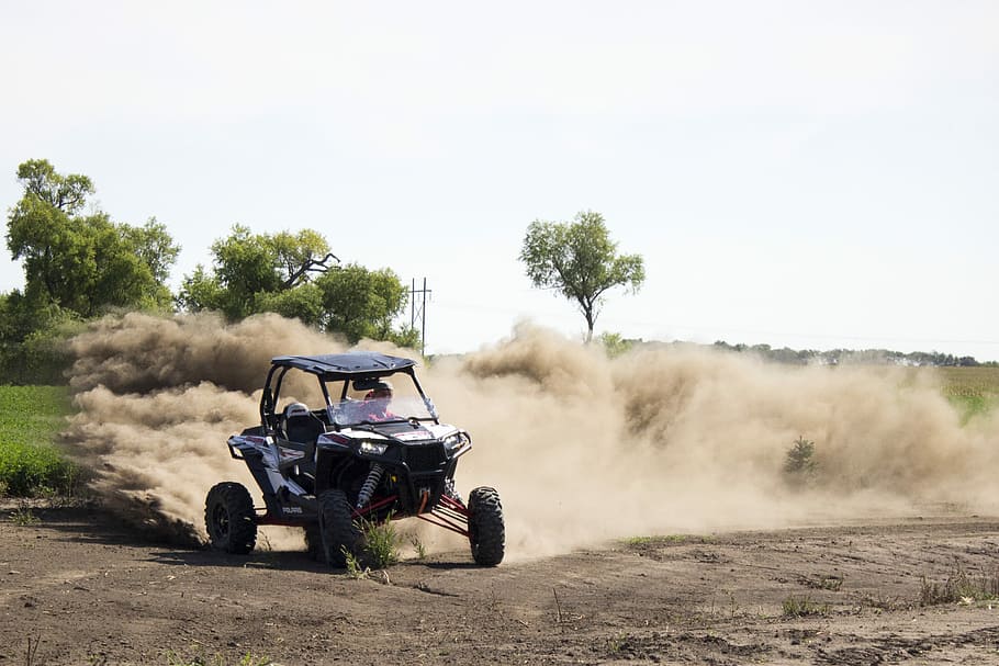 RZR Fun!, person riding dune buggy during daytime, dust, dirt