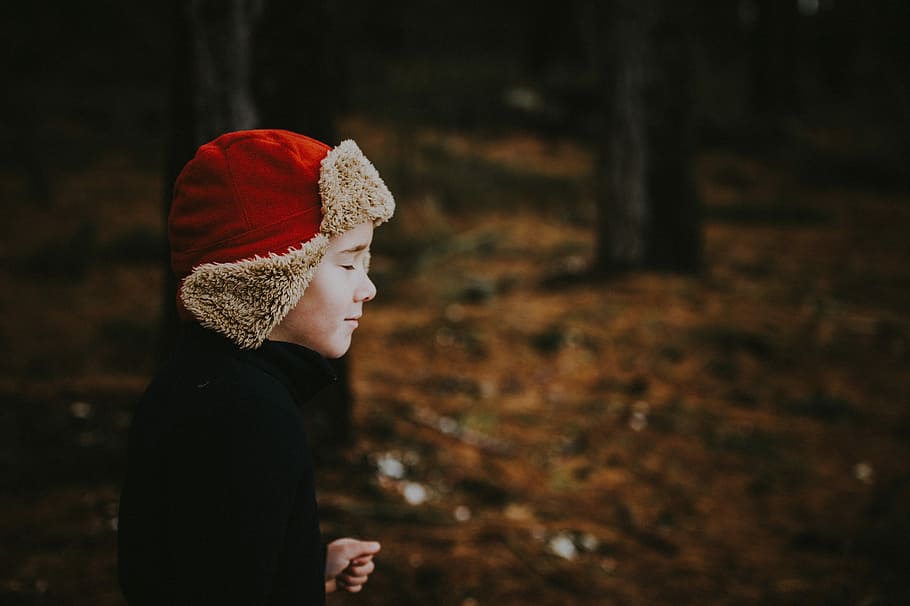 Boy in the woods, person wearing chullo hat standing outdoor