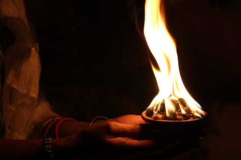 man holding cup of charcoal fire, diya, light, flame, celebration HD wallpaper
